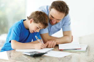 Father helping son with his schoolwork