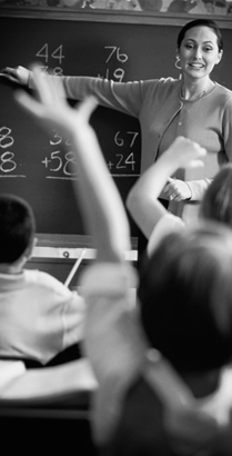 classroom with students and teacher at chalkboard